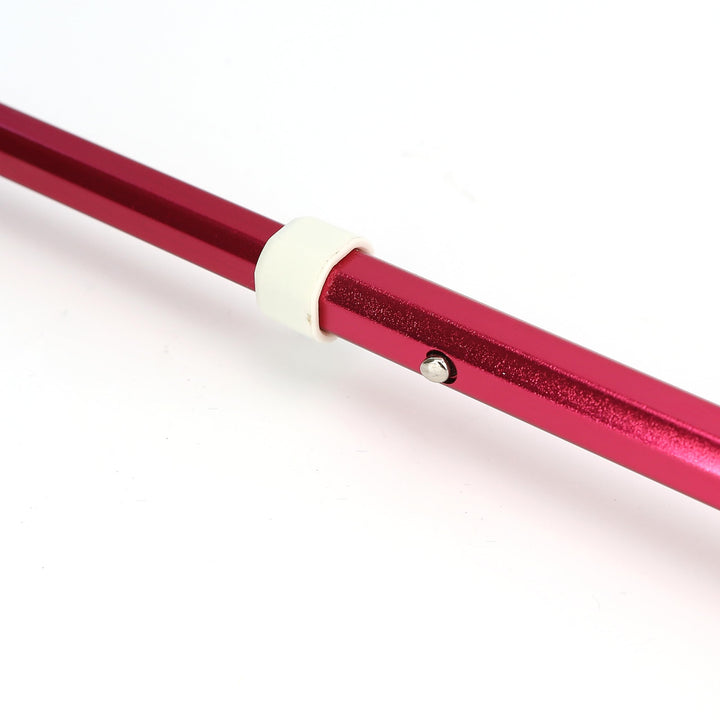 Close‑up of spring‑loaded locking button mechanism on aluminum‑alloy telescopic blind cane shaft